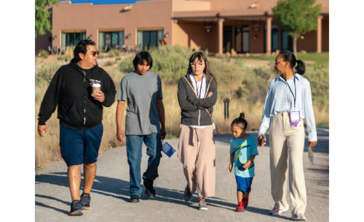 Counselor walking with family of four